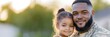 © Dibos - African american veteran soldier in uniform hugs his little daughter touchingly and tightly while standing in front of their house