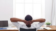 © Prostock-studio - Successful business background. Relaxed black businessman in casual view from back with copy space on window.