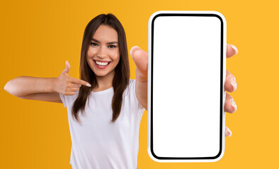 Aufkleber - Check This Website. Portrait of smiling female holding smartphone with white blank screen in hand, showing device close up to camera and pointing finger at gadget with empty free space for mock up