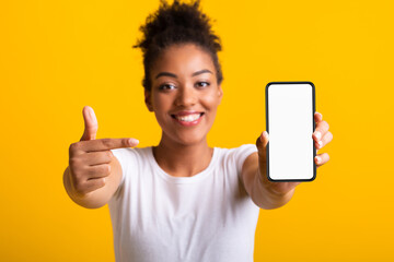 Aufkleber - Choose This. Black woman presenting cell phone with white blank screen for mockup, orange wall, empty space