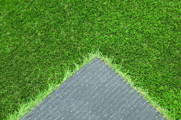 Wall Mural - Sheet of artificial turf as background, closeup