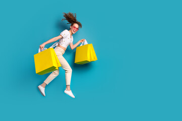 Sticker - Full body photo of young woman heart sunglass shopping bags jump runner dressed stylish white clothes isolated on blue color background