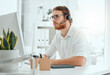 © peopleimages.com - Call center, man and consultant with headset on computer for customer service, technical support and online advice. Telemarketing, agent and help desk operator with microphone for assistance or CRM