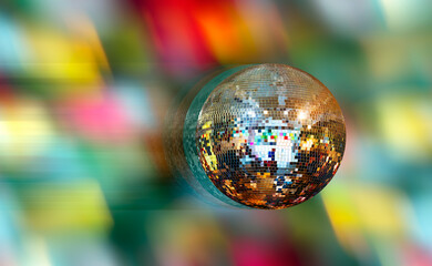 Party disco mirror ball reflecting orange and green lights