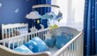 © stéphane huvé - Baby mobile with clouds and moons hangs over a white crib with blue bedding