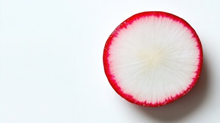 A fresh slice of radish with its bright red skin and white interior, set against a clean white backdrop