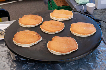 Pancakes lie and are baked on a griddle