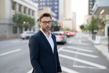 Happy young businessman in casual attire looking at camera. Smiling 40 year old mature confident professional manager, confident businessman investor looking at camera. Businessman on the street