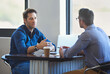 © ArcursForPI/peopleimages.com - Meeting, laptop and business people in discussion at coffee shop for planning, conversation and talking. Professional, collaboration and men in restaurant on computer for feedback, review or teamwork