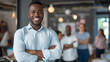 © Sascha - Portrait of a smiling, confident black male business leader standing with arms crossed looking at the camera, a group or team working in the style of in a modern office background.