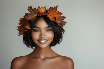 Wall Mural - Portrait of beautiful young smiling woman with wreath of autumn leafs. Healthy clean fresh skin natural make up beauty eyes on white background