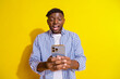 © deagreez - Photo of funky excited guy dressed checkered shirt modern device typing sms emtpy space isolated yellow color background