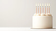 © enterdigital - A simple and elegant birthday cake with lit candles, perfect for celebrations and festive occasions.