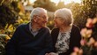 © Napasnan - A warm, candid portrait of grandparents sitting together, smiling lovingly at each other in a sunlit garden