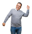 © Krakenimages.com - Middle age bussines arab man wearing glasses over isolated background Dancing happy and cheerful, smiling moving casual and confident listening to music