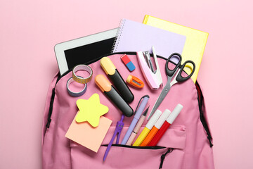 Sticker - Backpack and different school stationery on pink background, top view