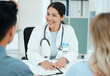 © KayExam/peopleimages.com - Hospital, talking and doctor with couple for consulting, wellness and fertility appointment in clinic. Healthcare, gynaecologist and man and woman for medical service, insurance and ivf treatment