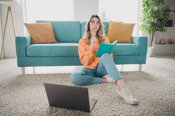 Sticker - Full length photo of cheerful girl sit floor netbook write notebook minded unsure dressed orange garment spacious house indoors room