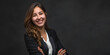© Saira - Confident Businesswoman Smiling with Arms Crossed in Professional Suit Posing Against Dark Background for Corporate Portrait Photography
