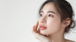 © Nittaya - Beautiful young asian woman touch her gently face skin isolated on white background, present her fresh skin, template for beauty product advertising