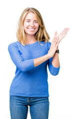 Beautiful young woman wearing blue sweater over isolated background Clapping and applauding happy and joyful, smiling proud hands together