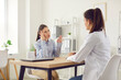 © Studio Romantic - Young woman complaining to doctor therapist at meeting, sitting at work table in hospital, physician consulting patient about headache, checkup results, giving recommendations at medical appointment