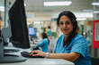 © AI_images_for_people - A Brazilian nurse, dressed in crisp scrubs, answering a phone call while managing patient information on a desktop PC at the hospital reception desk. The atmosphere is welcoming and professional.