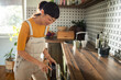 © Geber86 - Woman using dishwasher in kitchen with modern decor