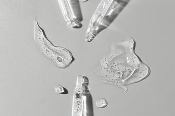 Poster - Cosmetic serum and pipettes on grey background, flat lay