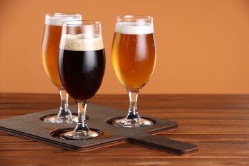 Wall Mural - Glasses with different types of beer on wooden table