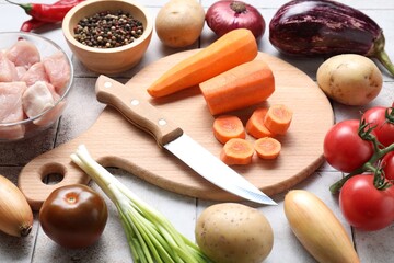 Sticker - Uncooked ingredients for stew on tiled table, closeup