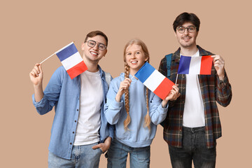 Group of students with French flags on beige background