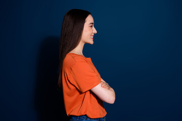 Poster - Photo of adorable gorgeous woman wear orange stylish clothes folded arms empty space isolated on dark blue color background