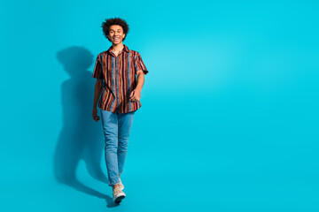 Poster - Full size photo of nice young man walk empty space wear shirt isolated on teal color background