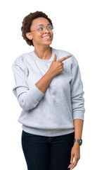 Young beautiful african american woman wearing glasses over isolated background cheerful with a smile of face pointing with hand and finger up to the side with happy and natural expression on face