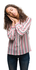 Wall Mural - Beautiful young hispanic woman sleeping tired dreaming and posing with hands together while smiling with closed eyes.