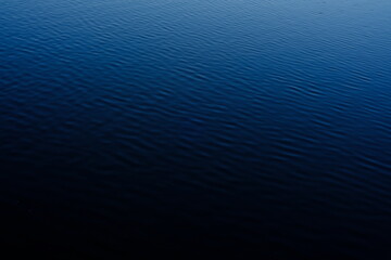 blue calm water surface texture, water patterns, blue sky reflections