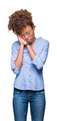 Beautiful young african american business woman over isolated background sleeping tired dreaming and posing with hands together while smiling with closed eyes.