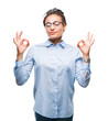 © Krakenimages.com - Young braided hair african american business girl wearing glasses over isolated background relax and smiling with eyes closed doing meditation gesture with fingers. Yoga concept.