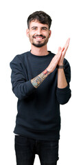 Young handsome man over isolated background Clapping and applauding happy and joyful, smiling proud hands together