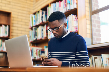 Poster - Phone, typing and black man with laptop in library at university for education, communication or online chat. Computer, smartphone and college student on mobile app for schedule, research or project