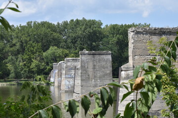 old concrete deserted bridge supports on river