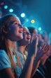 © vefimov - A group of young girls are clapping and smiling at a concert. Scene is joyful and energetic, as the girls are enjoying the music and the atmosphere of the event