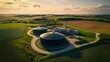 © Jack - Overview of a rural biogas plant processing agricultural waste, with digesters and tanks surrounded by fields