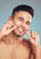 Poster - Studio, portrait and man with floss for dental hygiene, gum health and wellness with cleaning for fresh breath. Male model, teeth and string by gray background for mouth, gingivitis and oral care