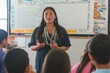© Artem Zatsepilin - female teacher teaching children their language in classroom . Native American heritage day