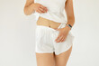 © Shkriabii - attractive girl in white underwear isolated on white background, girl in shorts and t-shirt