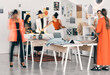 © CourtH/peopleimages.com - Teamwork, fashion designer or people in workshop for small business, textile pattern or creative clothes. Blur, production stylist or busy women in design agency for retail, modern style or startup