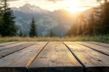 Wall Mural - Empty wooden table illuminating by setting sun over mountain landscape