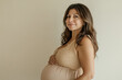 © Running opossum - Beautiful, multiracial pregnant woman in her 40s gently cradling her belly